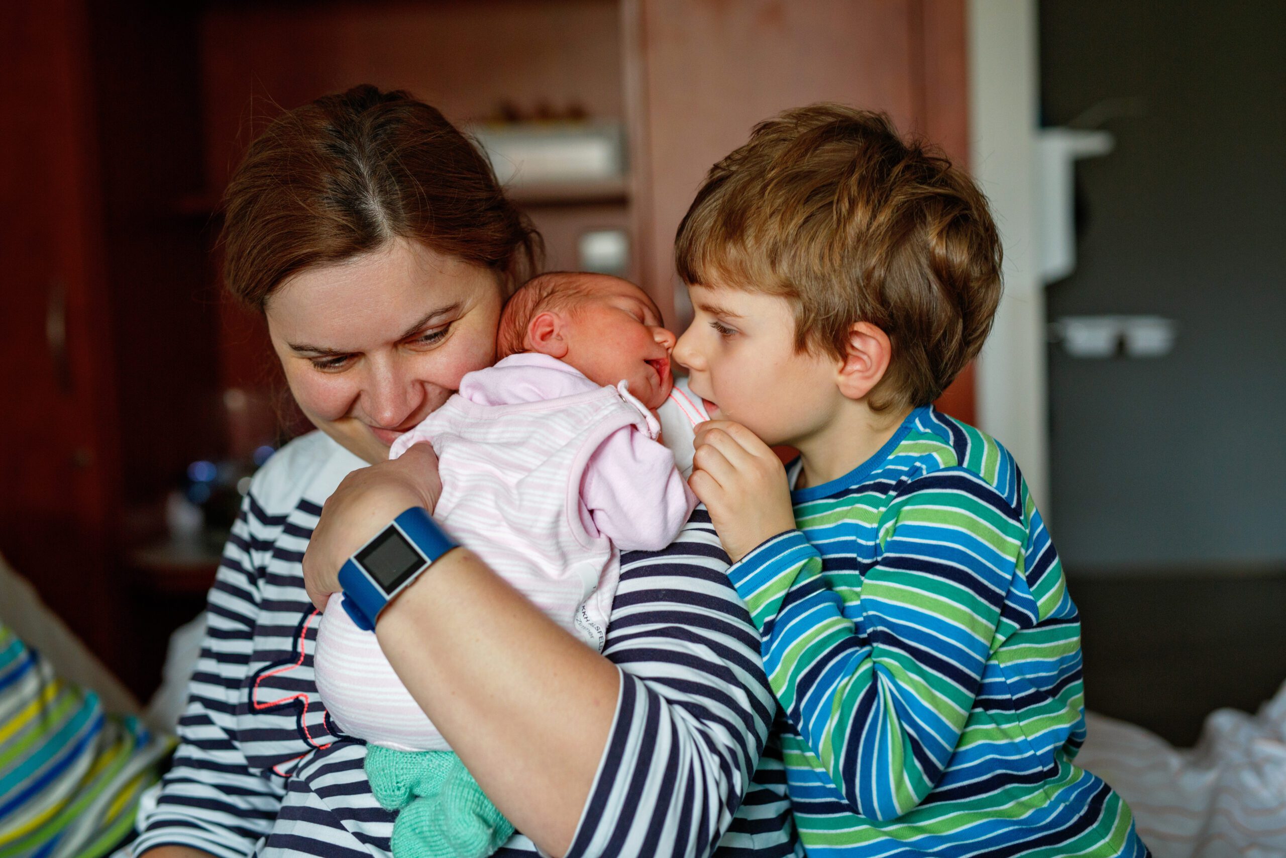 Surviving Infidelity mother holding newborn and younger sibling